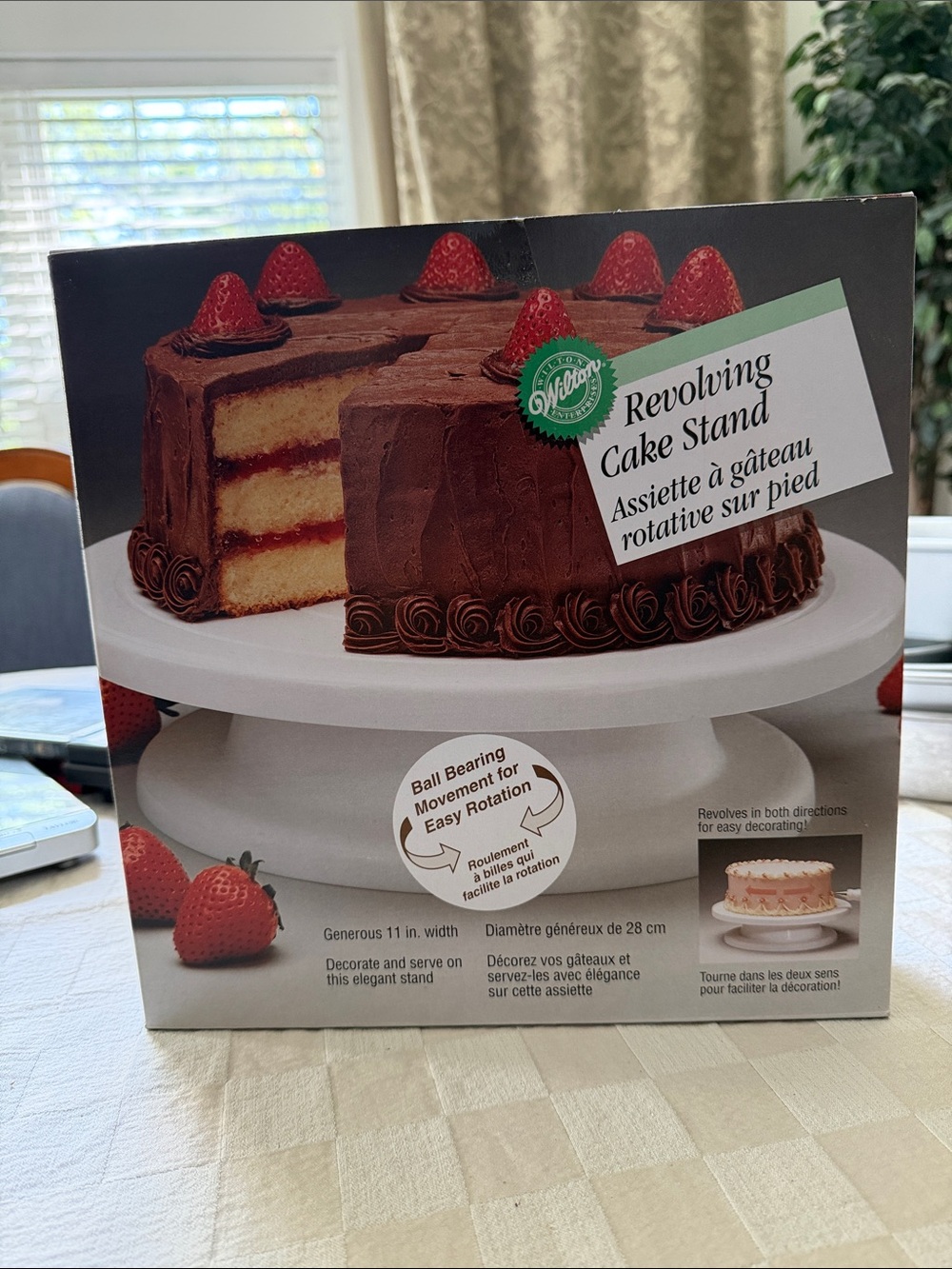 Wilton White Revolving Cake Stand with Red Accents on Packaging